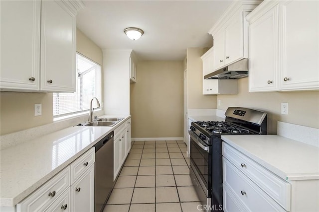 kitchen with appliances with stainless steel finishes, under cabinet range hood, a sink, and white cabinetry