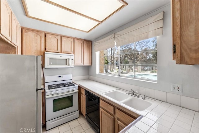 4591 Warner Ave Unit 105, Huntington Beach, CA 92649 - kitchen featuring white appliances, a sink, plenty of natural light, and light tile patterned flooring