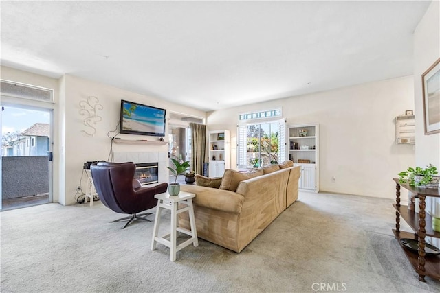 4591 Warner Ave Unit 105, Huntington Beach, CA 92649 - living room featuring carpet flooring and a tile fireplace