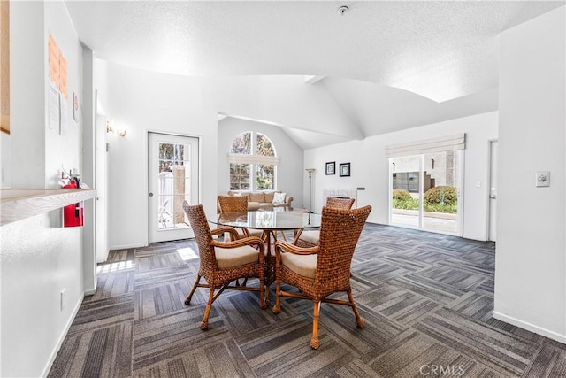 4591 Warner Ave Unit 105, Huntington Beach, CA 92649 - dining room with carpet flooring, a textured ceiling, baseboards, and lofted ceiling