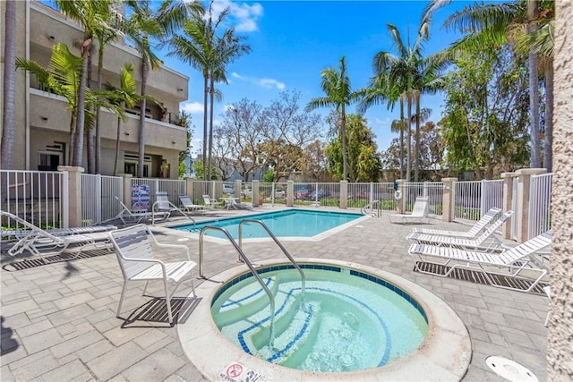 4591 Warner Ave Unit 105, Huntington Beach, CA 92649 - community pool featuring a hot tub, fence, and a patio area