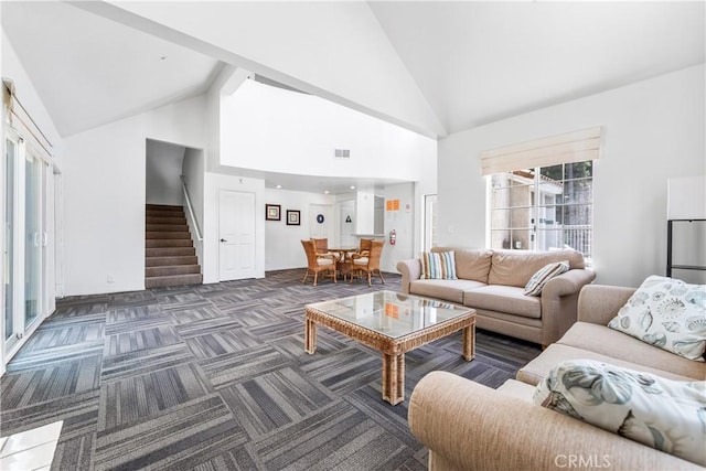 4591 Warner Ave Unit 105, Huntington Beach, CA 92649 - living room with stairs, high vaulted ceiling, and carpet