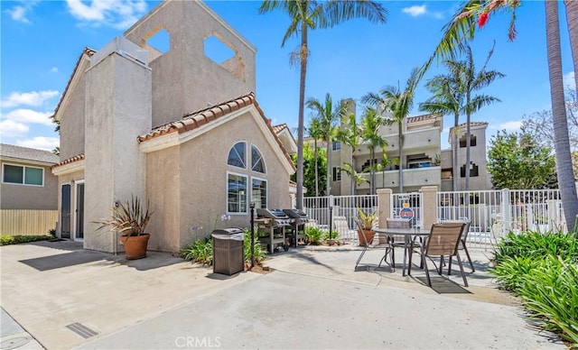 4591 Warner Ave Unit 105, Huntington Beach, CA 92649 - view of patio with fence, grilling area, and outdoor dining area