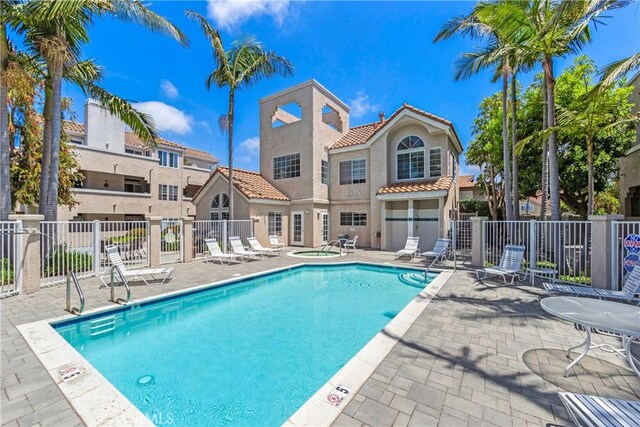 4591 Warner Ave Unit 105, Huntington Beach, CA 92649 - community pool with fence, a patio, and a hot tub
