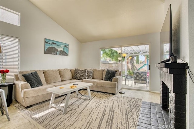 tiled living room with a brick fireplace and high vaulted ceiling