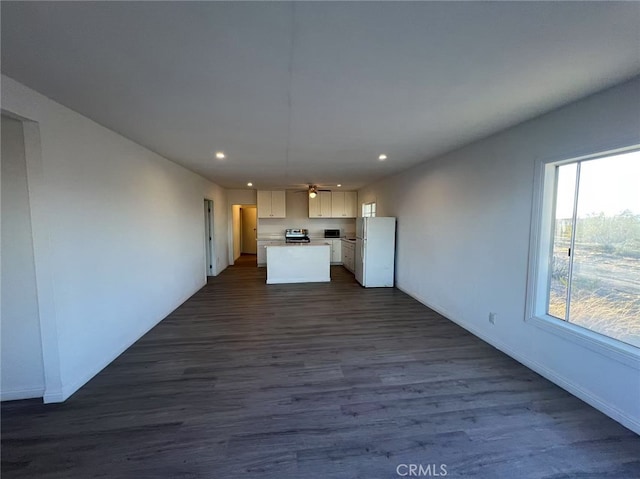 1754 Fortuna Ave, Landers, CA 92285 - kitchen with freestanding refrigerator, recessed lighting, open floor plan, a kitchen island, and dark wood-style flooring