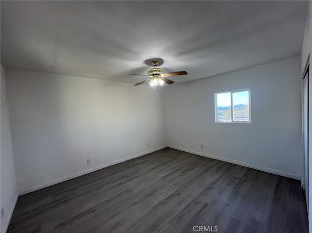 1754 Fortuna Ave, Landers, CA 92285 - empty room with dark wood finished floors, a ceiling fan, and baseboards