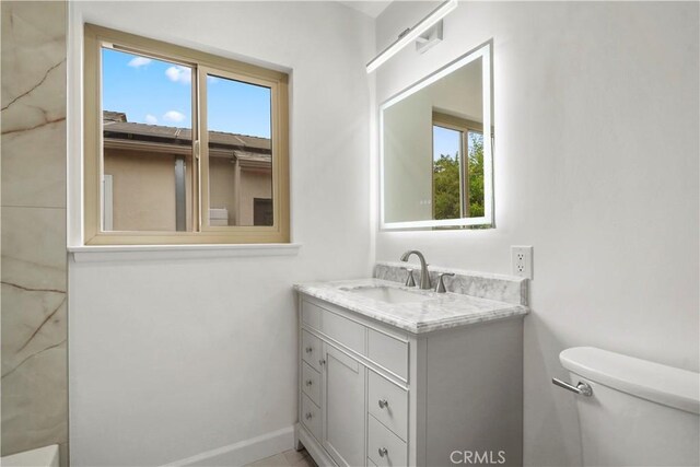 8331 Sharp Ave, Sun Valley, CA 91352 - bathroom with toilet, vanity, and baseboards