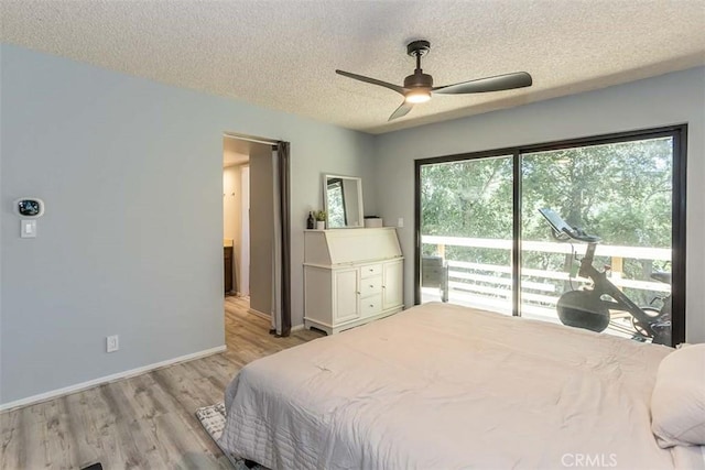 bedroom featuring light wood-type flooring, a textured ceiling, baseboards, a ceiling fan, and access to outside