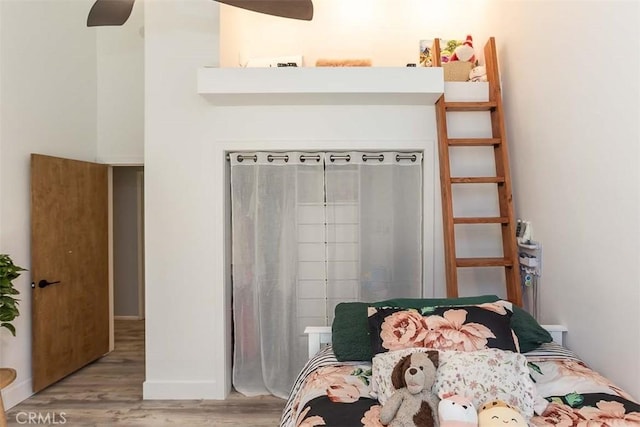 bedroom with wood finished floors and baseboards