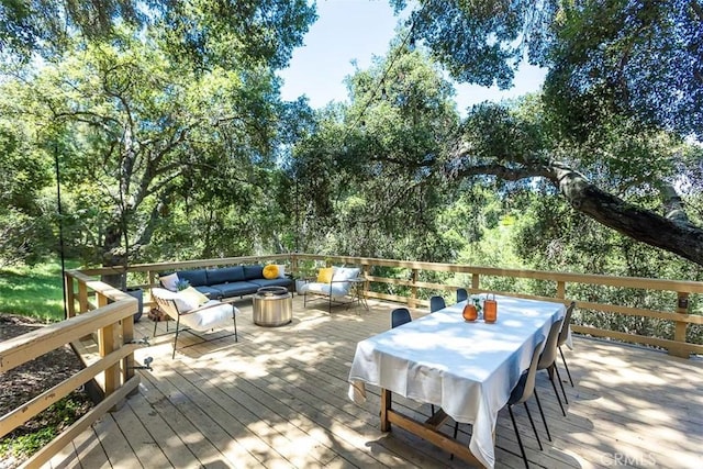 deck with outdoor lounge area and outdoor dining area