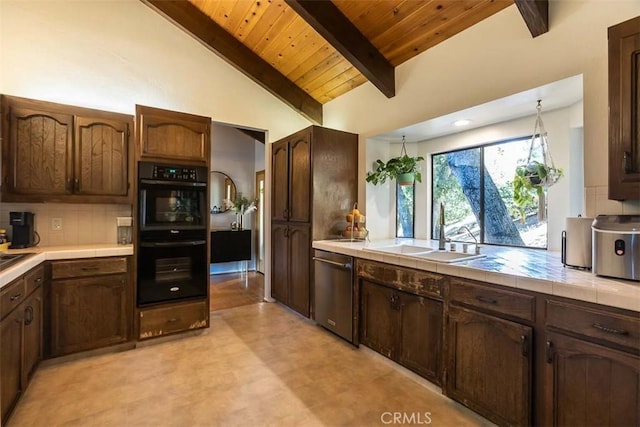 kitchen featuring a sink, dishwasher, tile countertops, light floors, and wood ceiling