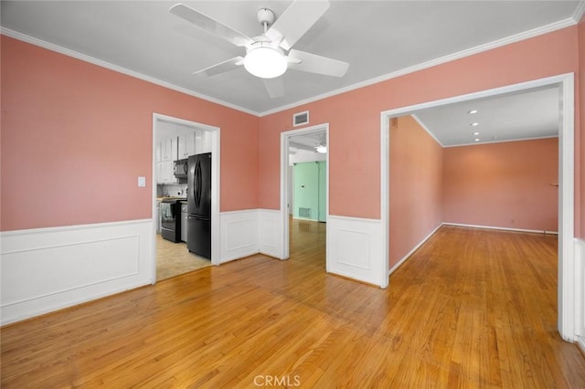 5422 E Harvey Way, Long Beach, CA 90808 - unfurnished room with a ceiling fan, light wood-style floors, crown molding, and a wainscoted wall