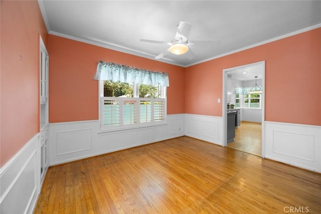 5422 E Harvey Way, Long Beach, CA 90808 - spare room featuring wainscoting, ornamental molding, light wood finished floors, ceiling fan, and a decorative wall