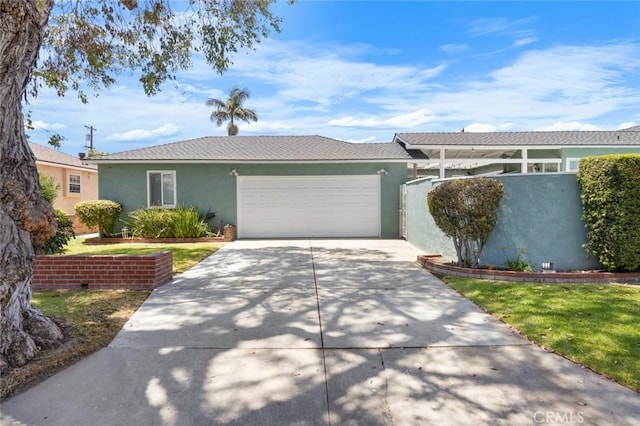 5422 E Harvey Way, Long Beach, CA 90808 - view of front facade with stucco siding, a garage, and driveway