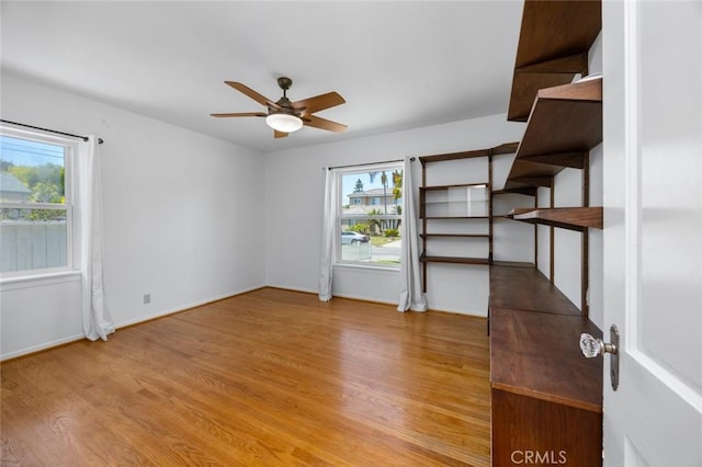 5422 E Harvey Way, Long Beach, CA 90808 - unfurnished bedroom featuring multiple windows, wood finished floors, and baseboards