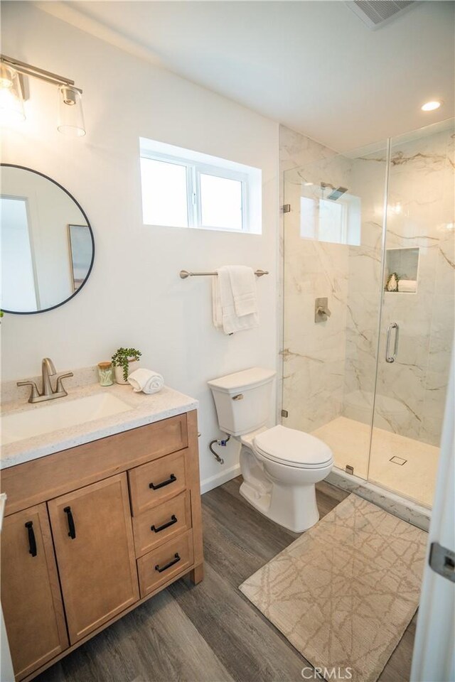 4110 E Vermont St, Long Beach, CA 90814 - full bathroom with toilet, a marble finish shower, wood finished floors, and vanity