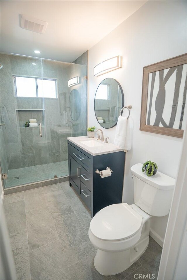 4110 E Vermont St, Long Beach, CA 90814 - bathroom with toilet, vanity, a stall shower, and baseboards