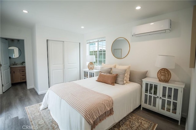 4110 E Vermont St, Long Beach, CA 90814 - bedroom with an AC wall unit, wood finished floors, a closet, recessed lighting, and a sink