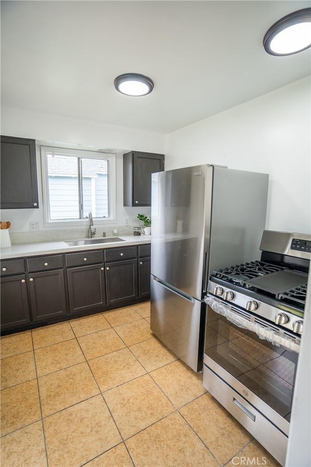 4110 E Vermont St, Long Beach, CA 90814 - kitchen featuring stainless steel appliances, a sink, light tile patterned floors, and light countertops