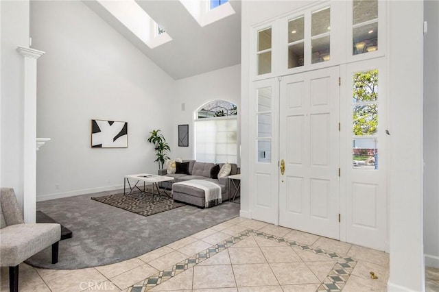 3232 Brimhall Dr, Los Alamitos, CA 90720 - entryway with high vaulted ceiling, plenty of natural light, baseboards, a skylight, and light tile patterned floors