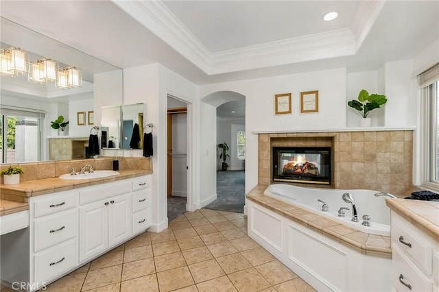 3232 Brimhall Dr, Los Alamitos, CA 90720 - bathroom featuring tile patterned floors, a tile fireplace, vanity, tasteful backsplash, and crown molding