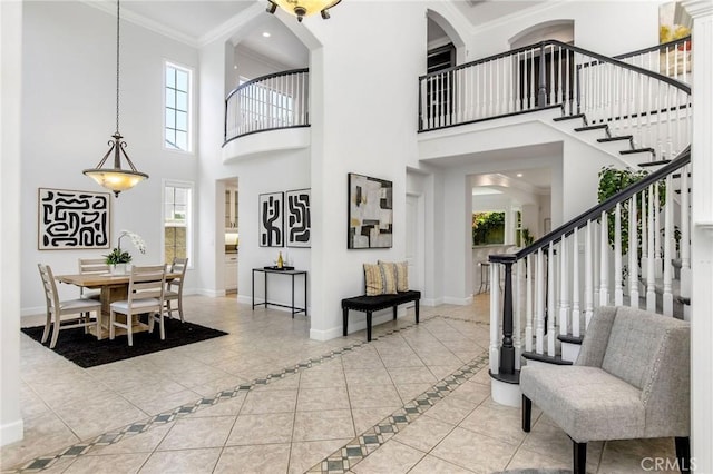 3232 Brimhall Dr, Los Alamitos, CA 90720 - tiled entryway with a high ceiling, baseboards, ornamental molding, and stairs