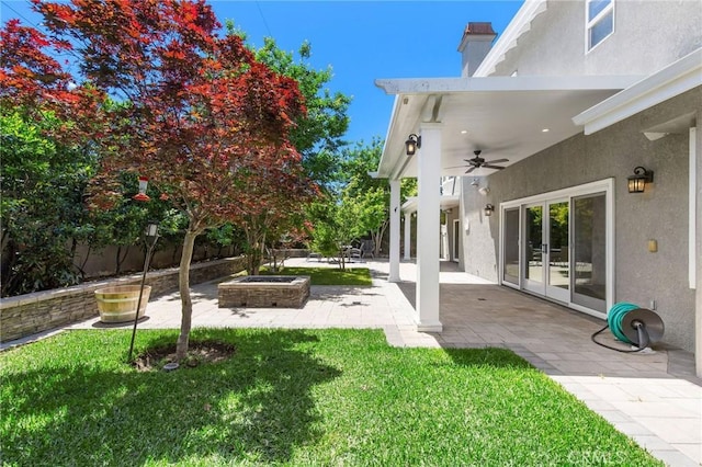 3232 Brimhall Dr, Los Alamitos, CA 90720 - view of grassy yard featuring a ceiling fan, a patio, and an outdoor fire pit