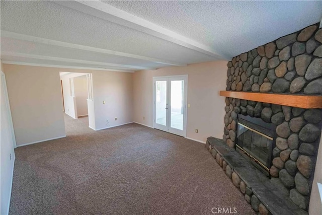 14410 Navajo Rd, Apple Valley, CA 92307 - unfurnished living room featuring a stone fireplace, carpet flooring, a textured ceiling, baseboards, and beam ceiling