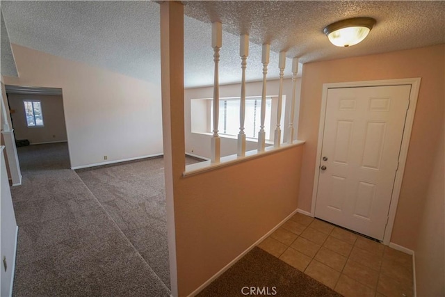 14410 Navajo Rd, Apple Valley, CA 92307 - doorway featuring baseboards, a textured ceiling, and tile patterned floors