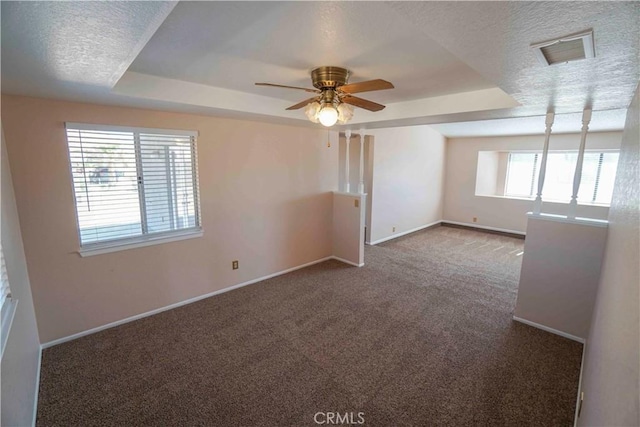 14410 Navajo Rd, Apple Valley, CA 92307 - spare room with carpet flooring, baseboards, a ceiling fan, a tray ceiling, and a textured ceiling