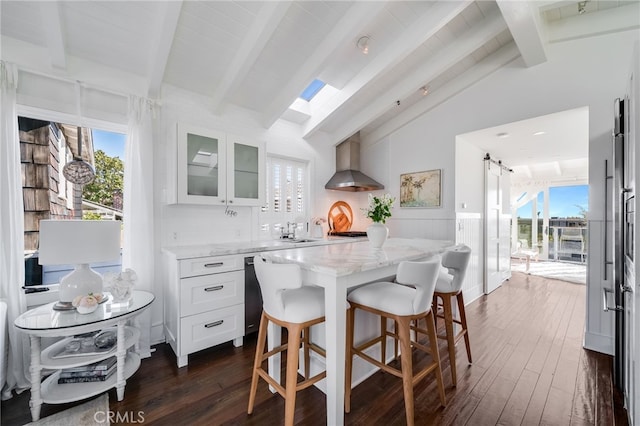 1651 Catalina, Laguna Beach, CA 92651 - kitchen with wall chimney exhaust hood, light stone counters, dark wood-type flooring, a barn door, and glass insert cabinets