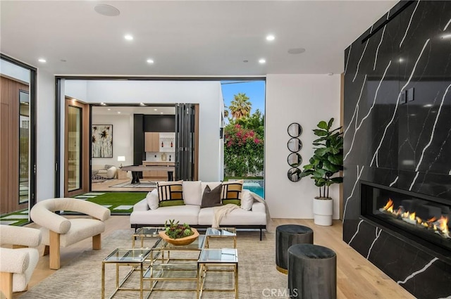 5132 Lindley Ave, Encino, CA 91316 - living room featuring floor to ceiling windows, wood finished floors, recessed lighting, and a premium fireplace