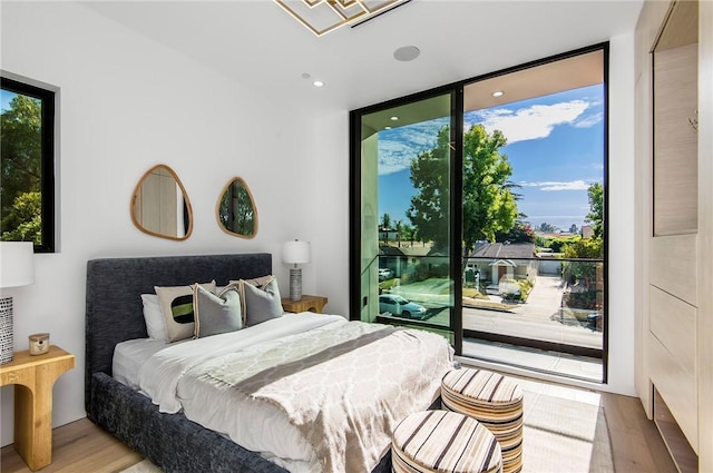 5132 Lindley Ave, Encino, CA 91316 - bedroom featuring a wall of windows, multiple windows, wood finished floors, access to exterior, and recessed lighting