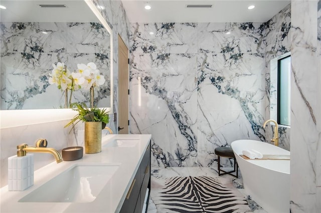 5132 Lindley Ave, Encino, CA 91316 - full bathroom featuring stone wall, recessed lighting, double vanity, a soaking tub, and tile walls