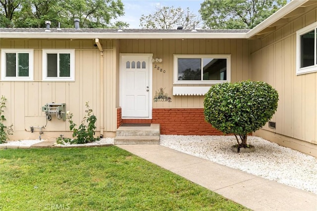 2880 Foothill Blvd, Oroville, CA 95966 - doorway to property featuring a yard, board and batten siding, and roof with shingles