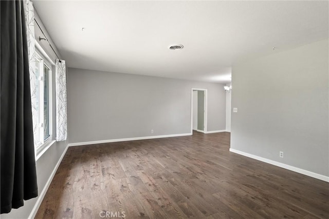 2880 Foothill Blvd, Oroville, CA 95966 - unfurnished room with dark wood-type flooring, a chandelier, and baseboards