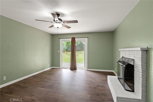 2880 Foothill Blvd, Oroville, CA 95966 - unfurnished living room with a ceiling fan, dark wood-style flooring, a brick fireplace, and baseboards