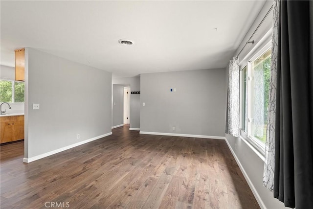 2880 Foothill Blvd, Oroville, CA 95966 - unfurnished room with wood finished floors, healthy amount of natural light, a sink, and baseboards