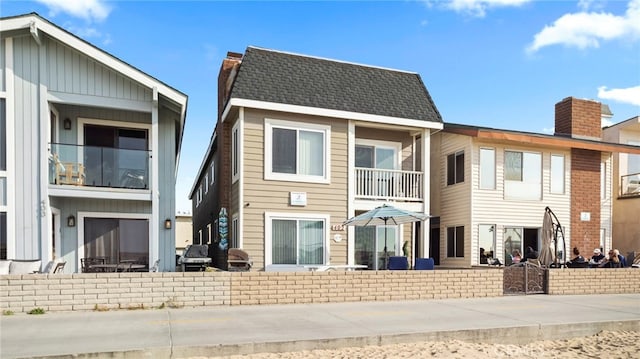 402 E Oceanfront, Newport Beach, CA 92661 - view of front of house with a chimney and a balcony
