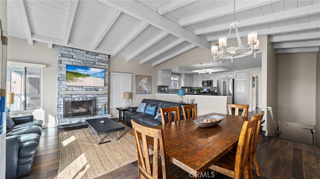 402 E Oceanfront, Newport Beach, CA 92661 - dining space featuring dark wood-style floors, a stone fireplace, and a chandelier