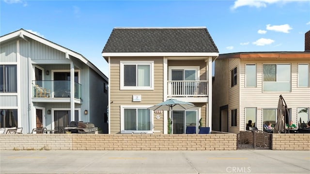402 E Oceanfront, Newport Beach, CA 92661 - back of house featuring a balcony and roof with shingles