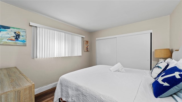 402 E Oceanfront, Newport Beach, CA 92661 - bedroom with wood finished floors, baseboards, and a closet