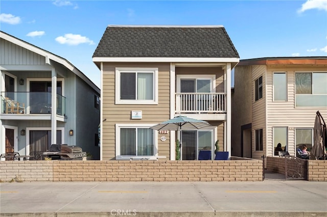 402 E Oceanfront, Newport Beach, CA 92661 - rear view of house featuring roof with shingles, an outdoor kitchen, and a balcony