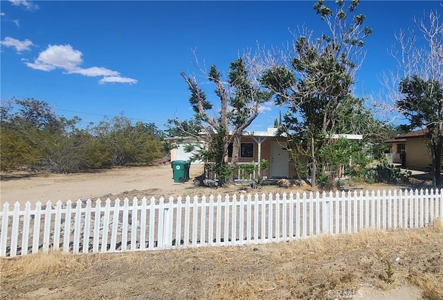 7067 Tamarisk Ave, Yucca Valley, CA 92284 - obstructed view of property with a fenced front yard