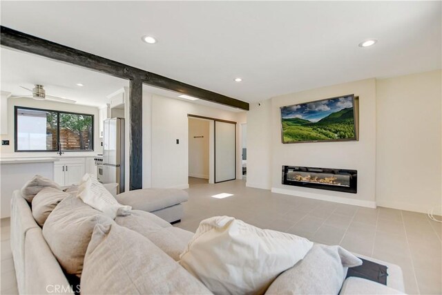 61461 El Reposo St, Joshua Tree, CA 92252 - living area with recessed lighting, baseboards, a glass covered fireplace, light tile patterned floors, and beamed ceiling
