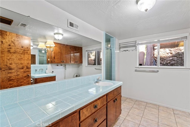 300 Pioneer Rd, Lake Arrowhead, CA 92352 - bathroom with tile patterned floors, a shower with door, vanity, a textured ceiling, and baseboards