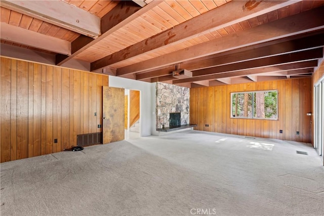 300 Pioneer Rd, Lake Arrowhead, CA 92352 - unfurnished living room with beamed ceiling, wooden walls, carpet flooring, a fireplace, and stairs