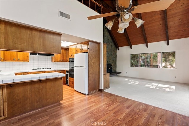 300 Pioneer Rd, Lake Arrowhead, CA 92352 - kitchen featuring freestanding refrigerator, tile countertops, a ceiling fan, cooktop, and black oven