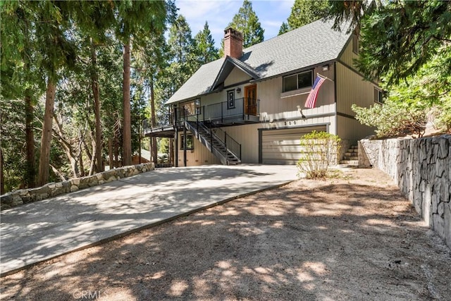 300 Pioneer Rd, Lake Arrowhead, CA 92352 - view of front of property with stairway, driveway, a chimney, an attached garage, and a shingled roof